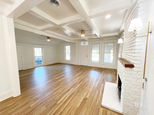 unfurnished living room with light hardwood / wood-style floors, beam ceiling, a fireplace, and ceiling fan