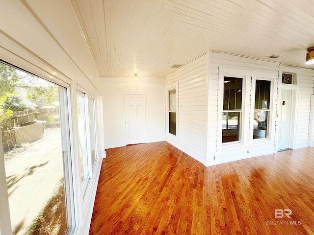 unfurnished sunroom with wood ceiling