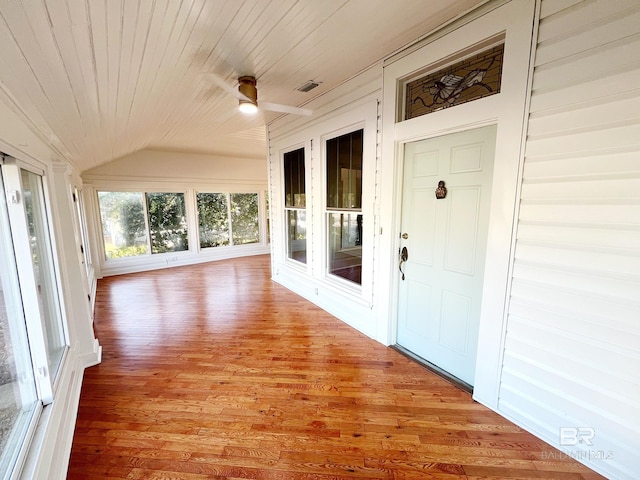 unfurnished sunroom with vaulted ceiling, wooden ceiling, and ceiling fan