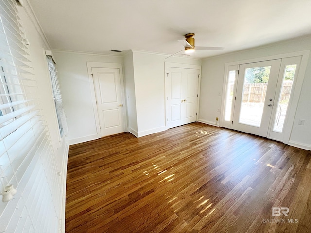 interior space featuring access to outside, ornamental molding, dark wood-type flooring, and ceiling fan