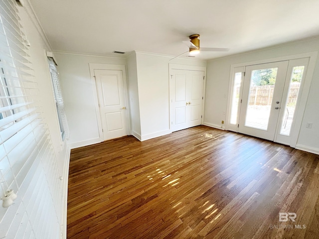 unfurnished bedroom featuring wood finished floors, access to exterior, visible vents, ornamental molding, and baseboards