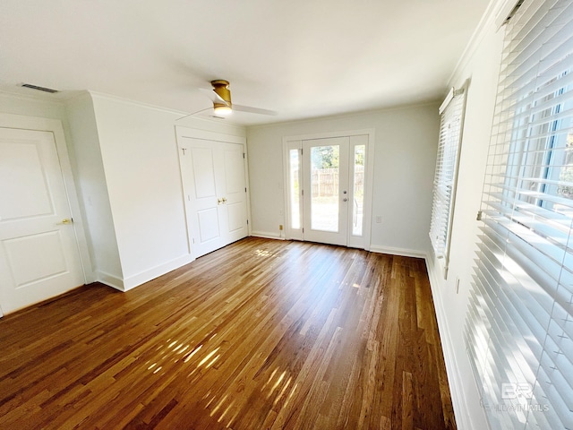 unfurnished bedroom featuring ornamental molding, dark hardwood / wood-style floors, access to exterior, and ceiling fan