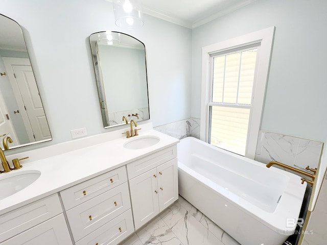bathroom with crown molding, a washtub, marble finish floor, and a sink