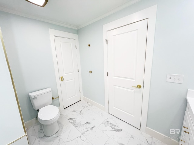 bathroom featuring vanity, toilet, and ornamental molding