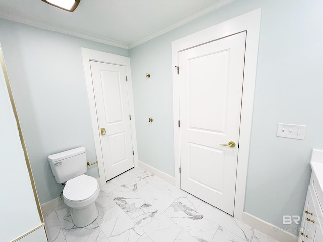 bathroom featuring marble finish floor, baseboards, toilet, and crown molding