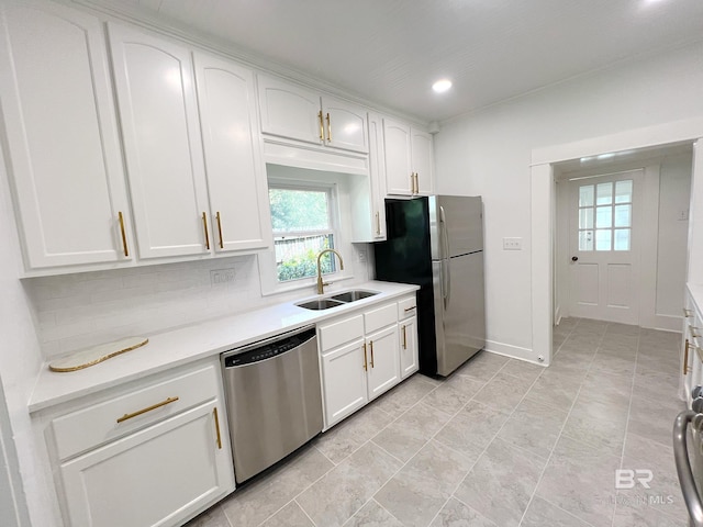 kitchen with decorative backsplash, white cabinets, light tile patterned floors, appliances with stainless steel finishes, and sink