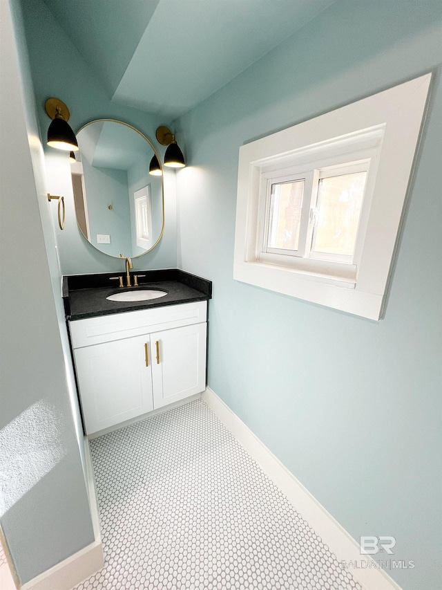 bathroom with baseboards and vanity