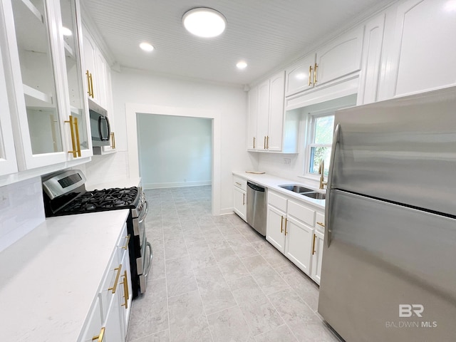 kitchen with appliances with stainless steel finishes, white cabinetry, and sink