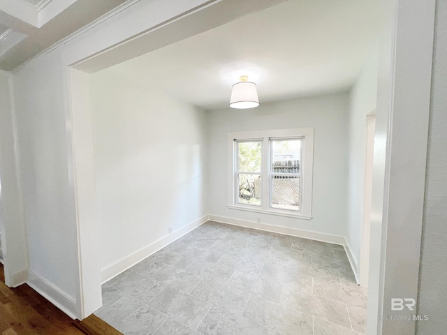 empty room with baseboards