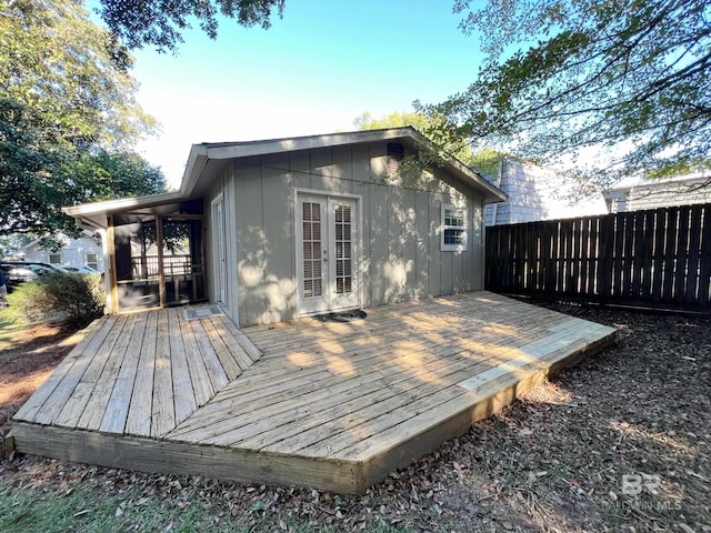 wooden terrace featuring french doors and fence