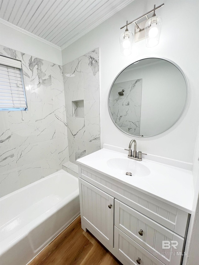 full bath with wood finished floors, crown molding, vanity, and bathtub / shower combination