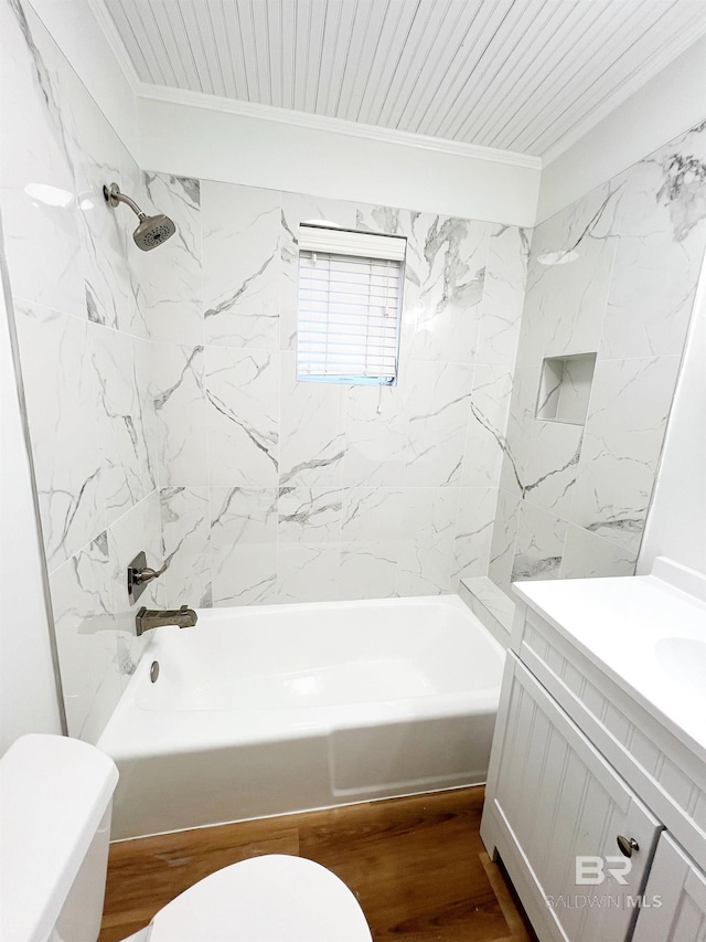 full bathroom featuring wood-type flooring, toilet, vanity, crown molding, and tiled shower / bath combo