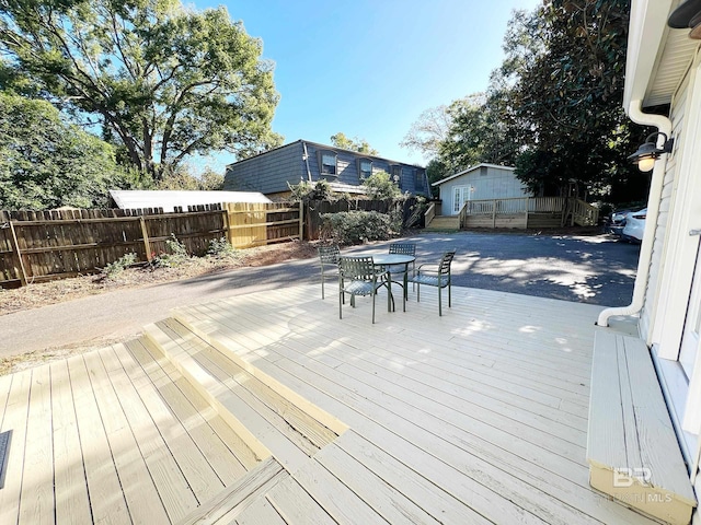 wooden deck featuring fence and outdoor dining space