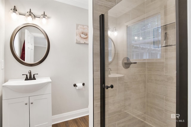 1508 Phillips Ln, Mobile, AL 36618 - full bathroom with a shower stall, vanity, baseboards, ornamental molding, and wood finished floors