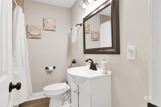 1508 Phillips Ln, Mobile, AL 36618 - full bath with vanity, toilet, baseboards, wood finished floors, and a shower with curtain