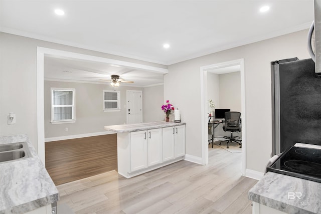 1508 Phillips Ln, Mobile, AL 36618 - kitchen featuring freestanding refrigerator, light wood-type flooring, ornamental molding, light countertops, and a peninsula