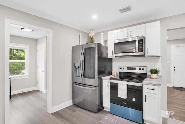 1508 Phillips Ln, Mobile, AL 36618 - kitchen featuring stainless steel appliances, decorative backsplash, white cabinets, light countertops, and baseboards