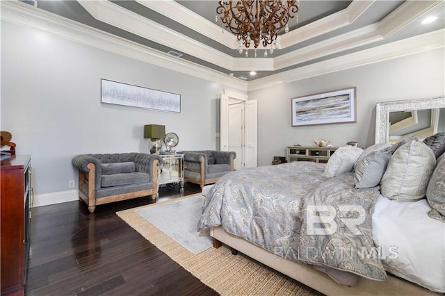 bedroom featuring crown molding, dark hardwood / wood-style floors, a notable chandelier, and a tray ceiling