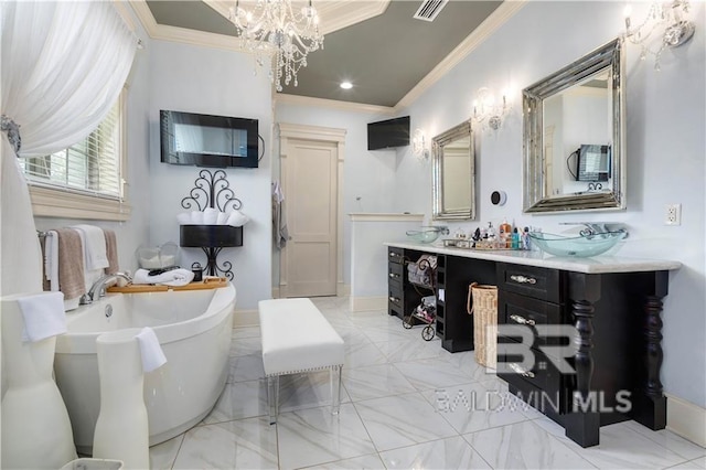 bathroom with crown molding, vanity, a bathing tub, and a notable chandelier