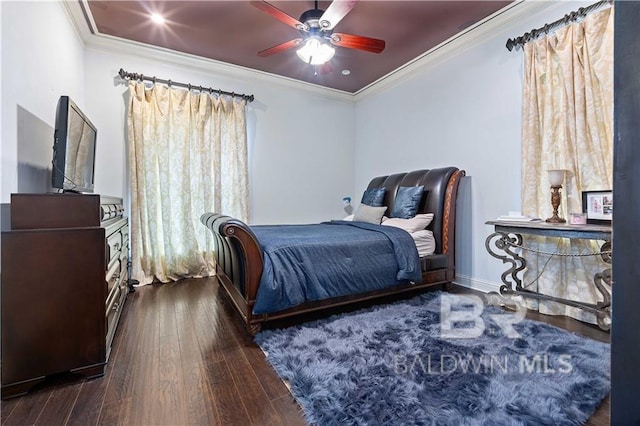 bedroom with crown molding, dark hardwood / wood-style floors, and ceiling fan