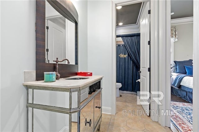 bathroom featuring crown molding, tile patterned floors, toilet, and vanity