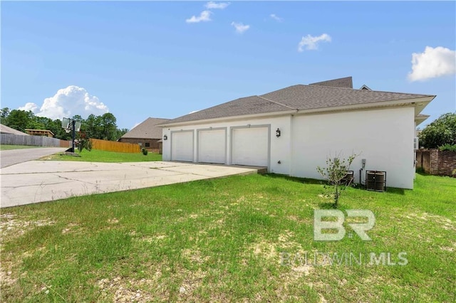 view of side of property with cooling unit, a garage, and a yard