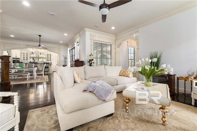 living room with crown molding, hardwood / wood-style floors, and ceiling fan