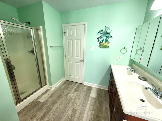 bathroom with vanity, hardwood / wood-style floors, and an enclosed shower