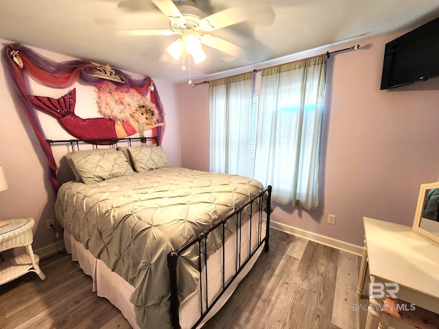 bedroom with ceiling fan, dark hardwood / wood-style floors, and multiple windows