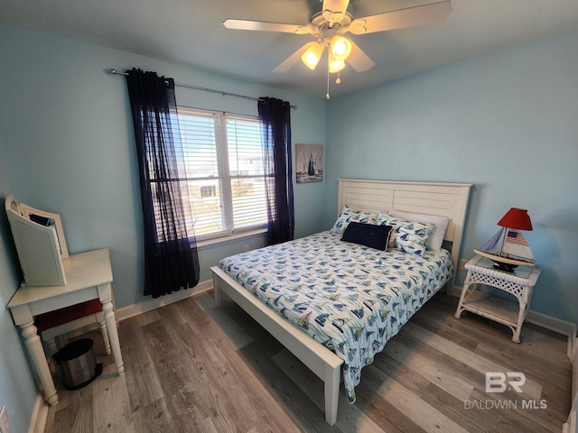 bedroom with ceiling fan and dark wood-type flooring