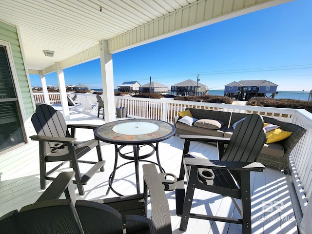 exterior space featuring a deck with water view