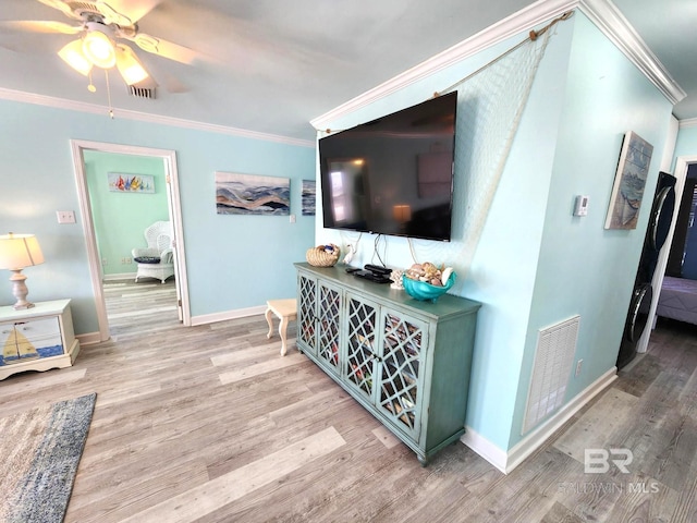 living room featuring ceiling fan, wood-type flooring, and crown molding