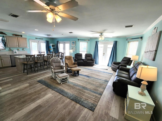 living room with ornamental molding, dark hardwood / wood-style floors, ceiling fan, and french doors