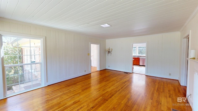 unfurnished room featuring baseboards and light wood-type flooring