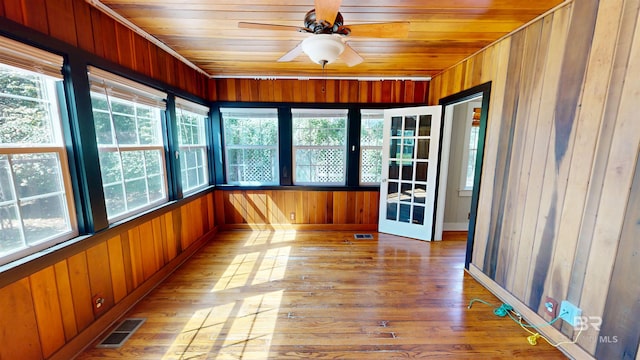 unfurnished sunroom with ceiling fan, visible vents, and wooden ceiling