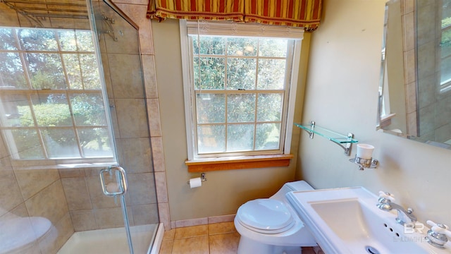 full bathroom with baseboards, toilet, a stall shower, tile patterned floors, and a sink