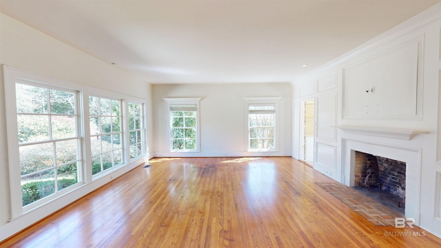 unfurnished living room featuring a fireplace and light wood-style floors