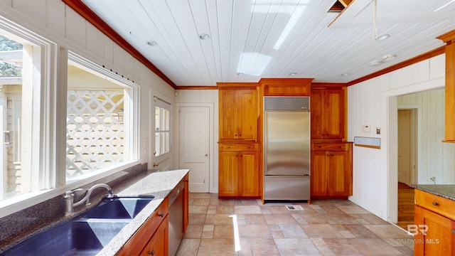 kitchen featuring a sink, appliances with stainless steel finishes, and brown cabinetry