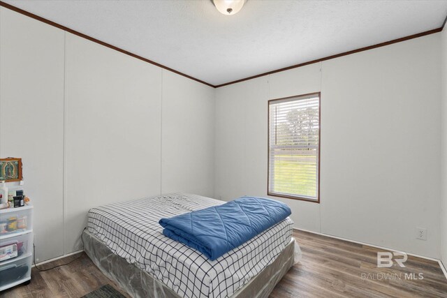 19300 Community Ln, Summerdale, AL 36580 - bedroom featuring ornamental molding and wood finished floors