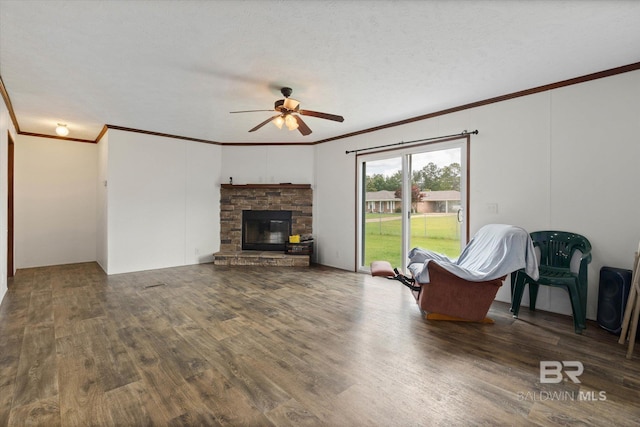 19300 Community Ln, Summerdale, AL 36580 - living area with ornamental molding, a ceiling fan, wood finished floors, and a stone fireplace