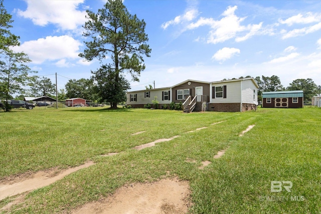 19300 Community Ln, Summerdale, AL 36580 - view of grassy yard featuring an outdoor structure