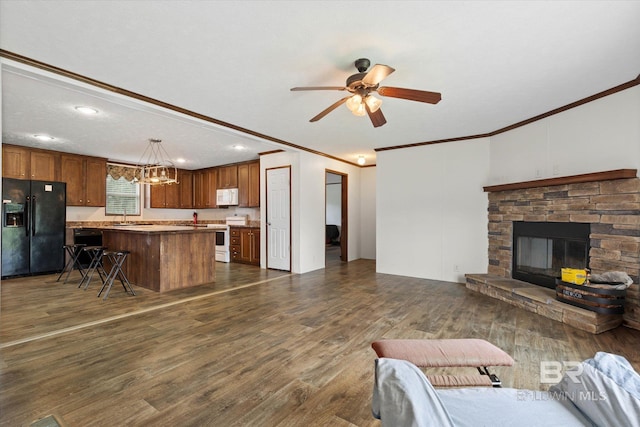 19300 Community Ln, Summerdale, AL 36580 - living room with ornamental molding, ceiling fan, a stone fireplace, dark wood-style floors, and recessed lighting