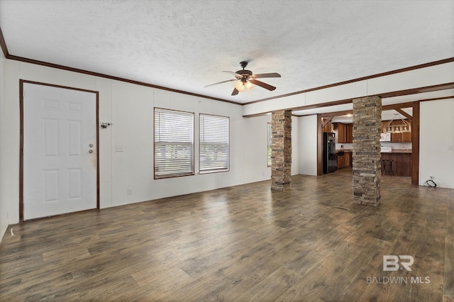 19300 Community Ln, Summerdale, AL 36580 - unfurnished living room with ornate columns, ornamental molding, ceiling fan, dark wood-type flooring, and a textured ceiling