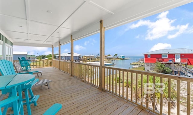 wooden deck featuring a water view