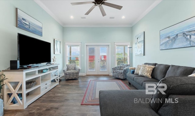 living room featuring french doors, dark wood-type flooring, crown molding, and ceiling fan