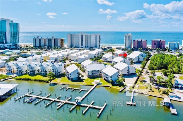 birds eye view of property with a water view and a city view