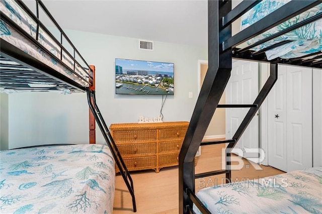 bedroom with wood finished floors and visible vents