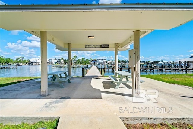 view of patio / terrace with a dock and a water view