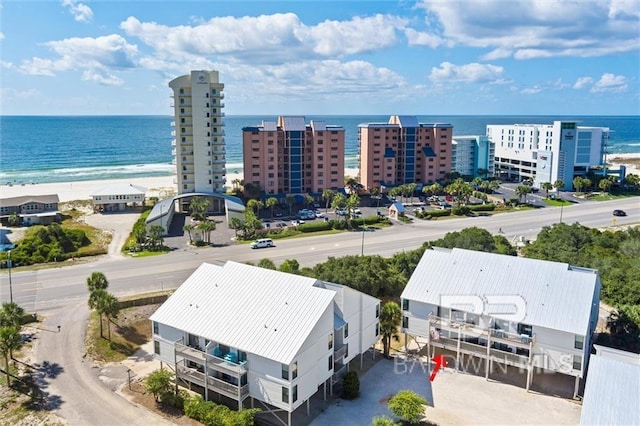 aerial view with a city view, a water view, and a beach view