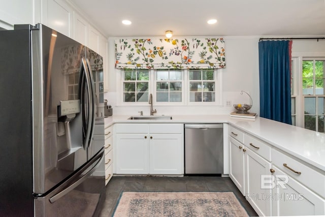 6000 Shenandoah Rd, Mobile, AL 36608 - kitchen with stainless steel appliances, a sink, white cabinets, light countertops, and recessed lighting